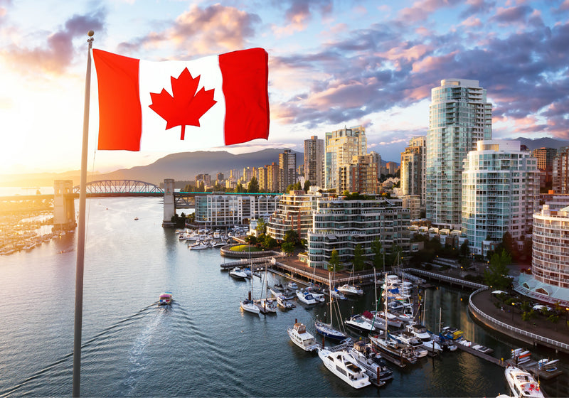 Canadian flag waving in front Vancouver, Waterfront, boats